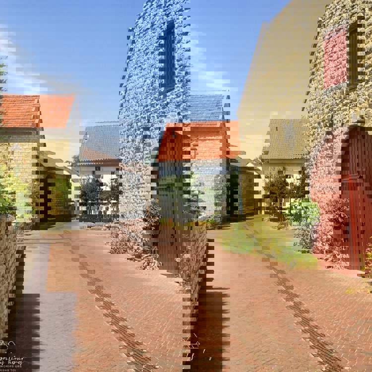 Straatje in een klein dorp met links en rechts huizen van mergel. 